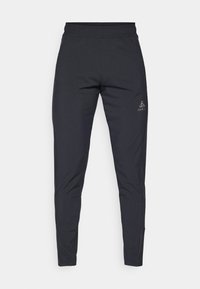 Svart treningsbukser laget av lett, elastisk materiale. Har elastisk midjebånd og en logo på venstre hofte. Slim fit-design.