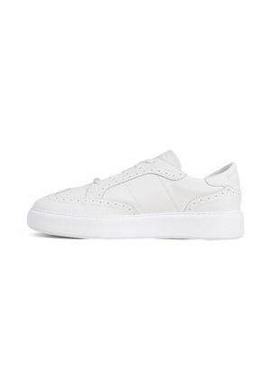 Low-top white leather sneaker with perforated detailing, thick rubber sole, and lace-up closure, shown in side profile on white background.