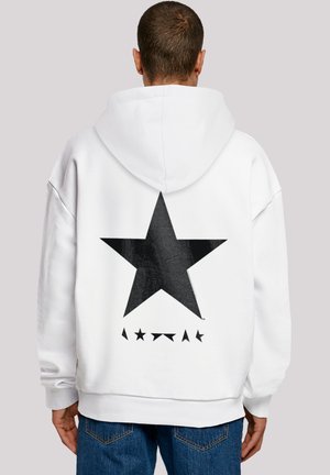 White hooded sweatshirt featuring a large black star design on the back, complemented by smaller black triangular accents below.