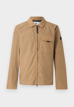 Brown lightweight jacket with a textured finish, front zipper, chest pocket, and a round logo patch on the left sleeve.