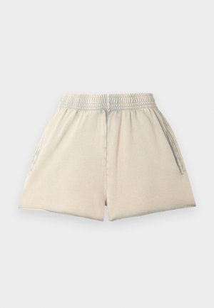 Pantaloni scurți din bumbac de culoare bej deschis, cu un elastic la talie, două buzunare laterale și o croială lejeră. Țesătura are o textură moale și o formă relaxată.