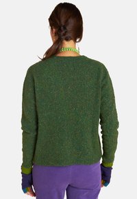 Green wool sweater with a textured finish, crew neck, and long sleeves. Features multicolored accents at the cuffs and a relaxed fit.