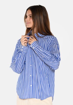 Blue and white striped button-up shirt with a collar, long sleeves, and a relaxed fit. Features visible buttons and side slits.
