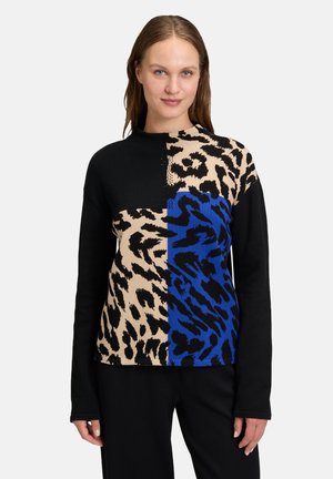 Knit pullover with a high neckline, featuring a split design in black, tan leopard print, and blue animal patterns. Long sleeves, soft texture.