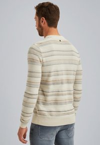 Light cream sweater with horizontal stripes in beige and gray. Features a round neckline and ribbed cuffs and hem. Soft, textured fabric.