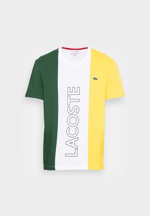 Lacoste T-shirt with green, white, and yellow vertical stripes. Features large "LACOSTE" text and a small logo on the left chest. Cotton blend.