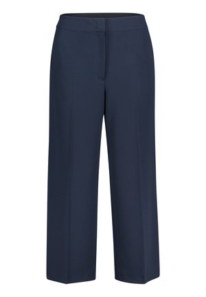 Pantalon large bleu marine en tissu lisse avec une ceinture élastique. Il comporte une poche avant et un ourlet net sans attaches visibles.