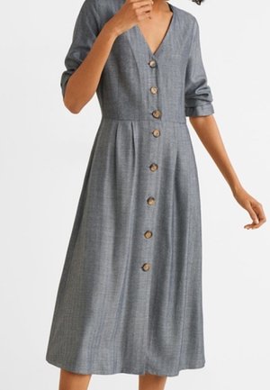 Grey button-up dress made of fabric with a textured finish. Features a deep V-neck, three-quarter sleeves, and wooden buttons along the front.