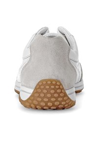 White athletic shoe featuring a smooth leather upper, a textured gray suede heel, and a brown rubber sole with round treads for traction.