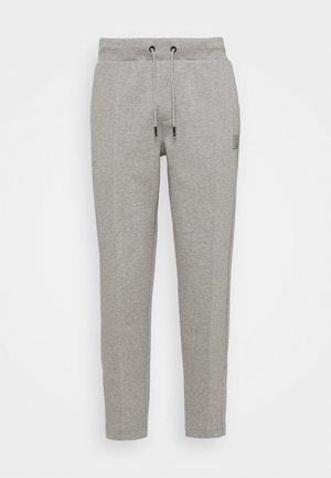 Lichtgrijze joggingbroek met elastische taille en trekkoord, rechte pijpen en een klein logo op de bovenkant van het bovenbeen.