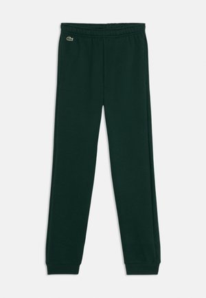 Pantalons de jogging en coton vert foncé avec une taille élastique et des poignets côtelés. Présente un petit logo Lacoste sur le côté gauche.