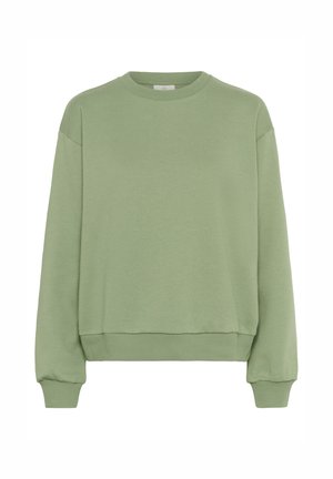 Zaļš džemperis, kas izgatavots no mīksta auduma. Iemanto kupliem kakla izgriezumiem, garām piedurknēm ar ribotiem galiem un ribotu apakšmalu, kas nodrošina brīvu piegriezumu.