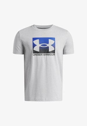 Maglietta a maniche corte grigio chiaro con un quadrato blu e nero con il logo bianco Under Armour e il testo "UNDER ARMOUR" sotto.