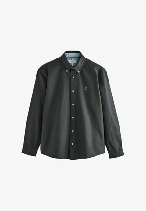 Black long-sleeve button-up shirt in cotton, featuring a pointed collar, light blue striped interior, and a small embroidered emblem on the chest.