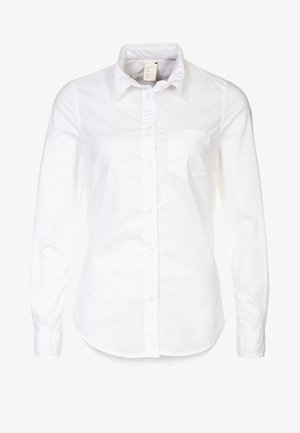 Chemise blanche à manches longues, boutonnée, en coton lisse, avec un col pointu, une poche poitrine unique et un ourlet incurvé.