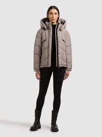 Dunjakke i lys grå med hætte, med quiltet design, sidelommer og lynlås foran. Kombineret med sorte leggings og støvler.