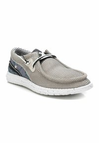 Zapato slip-on de malla en gris con un acabado texturizado. Presenta una suela blanca moteada y acentos en negro y con patrones contrastantes a lo largo de los costados.