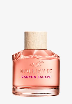 Glazen fles met roze Hollister Canyon Escape geur, een natuurlijke houten dop en een reliëflogo op een witte achtergrond.