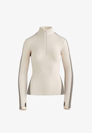 Top a maniche lunghe con collo con zip in beige chiaro e pannelli laterali grigi. Realizzato in materiale liscio ed elastico, con fori per il pollice nelle maniche.