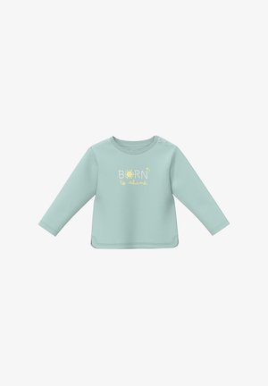 Chemise bébé à manches longues bleu clair avec des boutons pression aux épaules, arborant le texte « Né pour briller » et un graphique de soleil au centre devant.