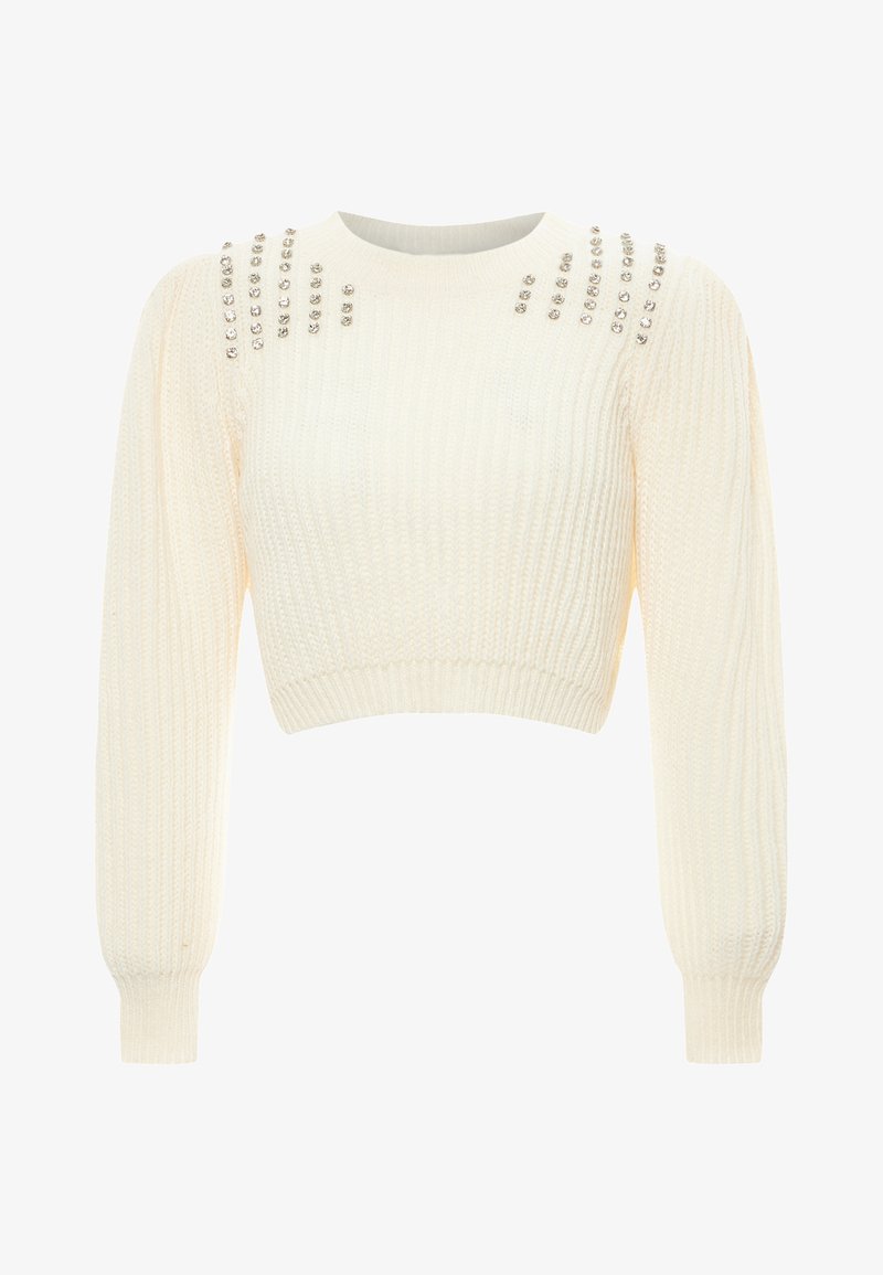 Krém színű, rövidített fazonú pulóver bordás textúrával, hosszú ujjak és díszes szegecsek a vállakon, amelyek extra részletességet adnak.