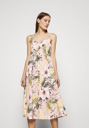 Floral dress featuring a pink background with yellow and green tropical leaf patterns, thin straps, a fitted bodice, and button detail.