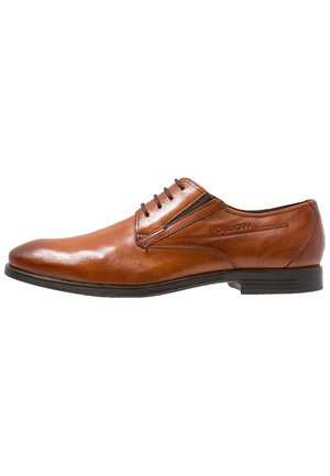 Zapato de vestir de hombre de cuero marrón pulido con cordones, tacón texturizado y suela negra, vista lateral sobre fondo blanco.