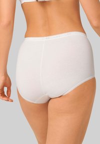 Mutande bianche in cotone a vita alta con delicata bordatura in pizzo lungo le aperture delle gambe. Design liscio e senza cuciture per il massimo del comfort.