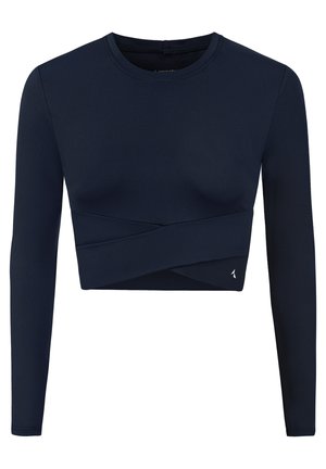 Crop top à manches longues bleu marine en tissu stretch, avec un design avant torsadé et un accent logo sur le bas à gauche.