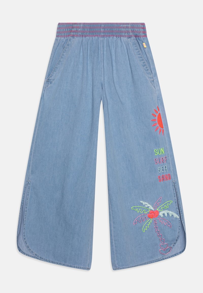 Pantalon bleu clair à jambes larges avec taille élastique, fentes latérales, et broderies colorées représentant un soleil, un palmier et les mots soleil, surf, mer, sable sur la jambe droite.