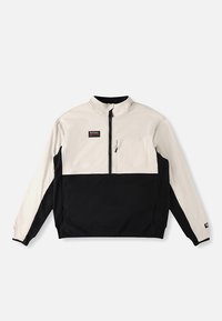 Giacca con mezza zip color crema e nero. Tasca frontale sul petto sinistro. Tessuto liscio con design a blocchi di colore a contrasto.