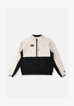 Halv-lynlås pulloverjakke i creme og sort. Frontlomme på venstre bryst. Glat stof med et kontrasterende farveblokdesign.