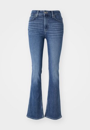 Flared blue jeans made of denim, featuring a high waist, fitted thighs, and wide openings at the bottom. Subtle whiskering detail on the front.