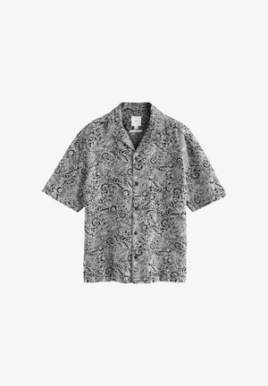 Short-sleeve shirt in black and white paisley pattern, featuring a button-up front and a relaxed fit, made from lightweight fabric.