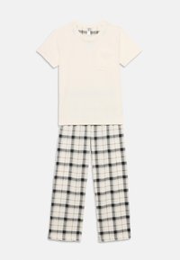 Σετ πυτζάμες από βαμβάκι που περιλαμβάνει ένα κρεμ πουκάμισο με κοντά μανίκια και τσέπη, καθώς και παντελόνι με καρό σχέδιο σε μαύρο και άσπρο. Χαλαρή εφαρμογή.