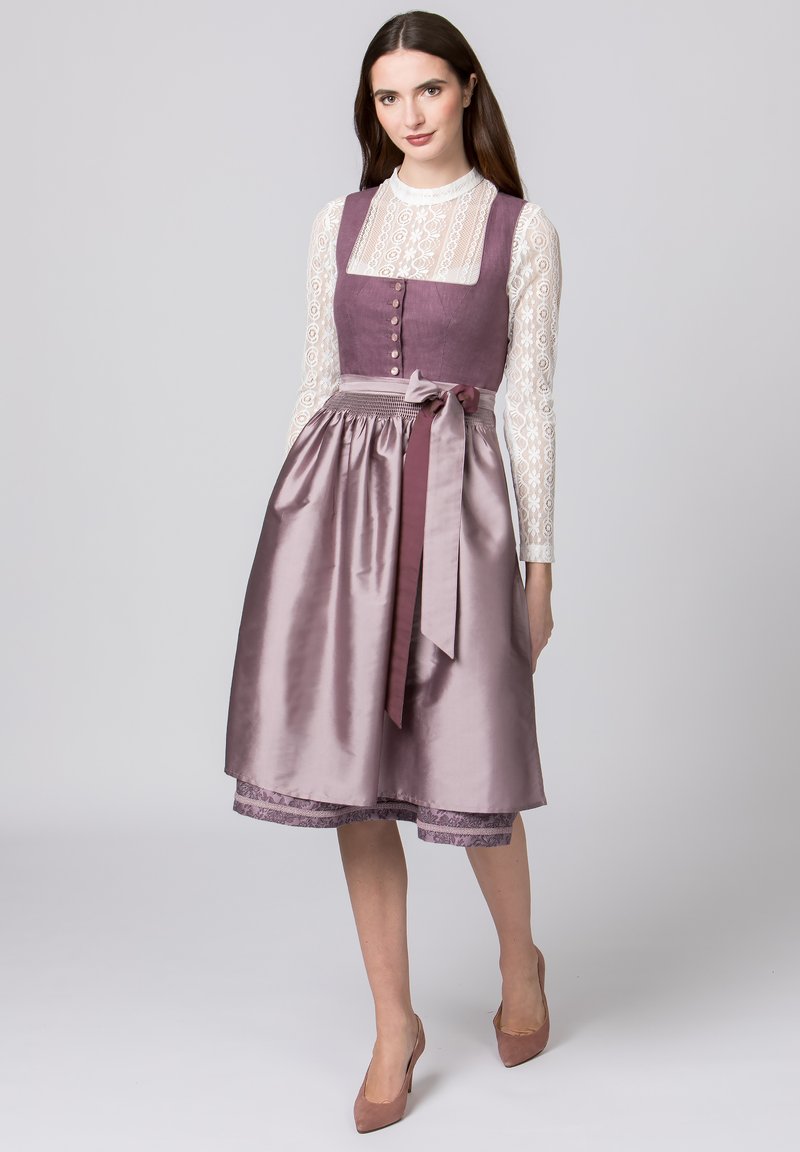 Purple satin dress with a fitted bodice, lace long-sleeve top, and a tied waist. Floral lace trim at the hem adds detail.