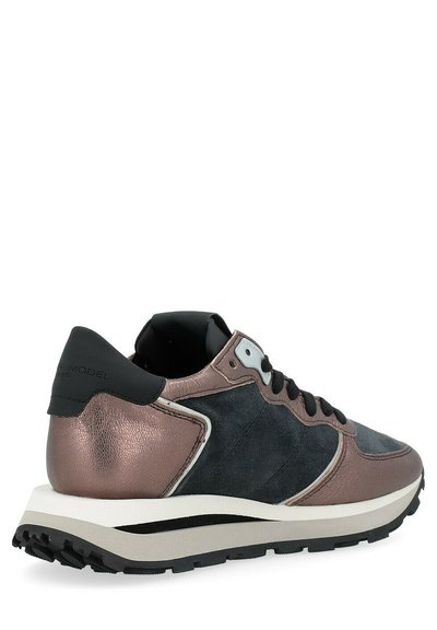 Sneaker featuring a black suede upper, metallic bronze accents, and a white midsole. Textured leather heel and rubber outsole displayed.
