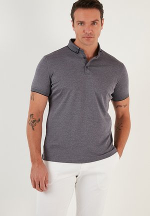 Gray polo shirt with a collared neckline, short sleeves, and a subtle texture. Features contrast stitching along the collar and sleeves.