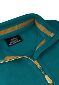 Türkisfarbene Fleece-Jacke mit Reißverschluss und goldenen Akzenten am Kragen, ausgestattet mit einem gelben Reißverschluss und einem Etikett mit der Aufschrift "Normani Outdoor Sports".