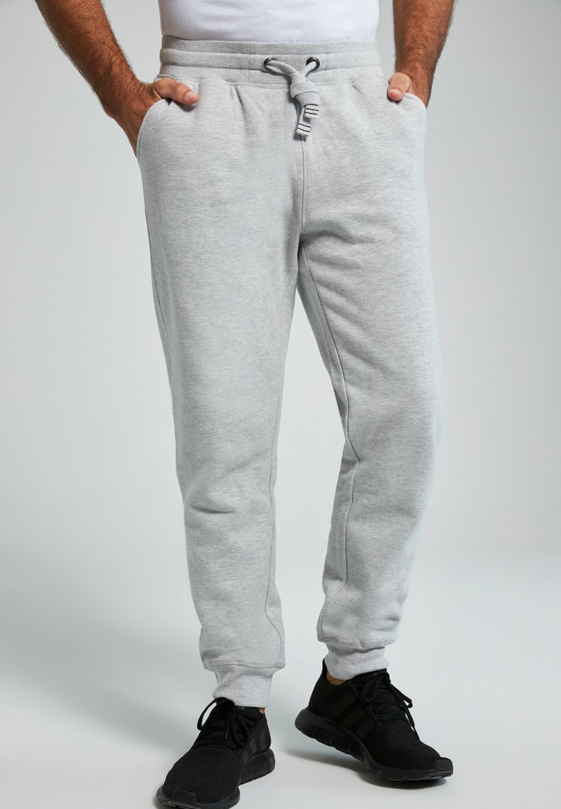 Lys grå bomulds joggers med elastisk talje, snøre lukning og sidelommer, med en tapered ben design.