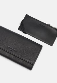 Czarny skórzany zestaw portfela i etui na karty, z teksturowanymi powierzchniami, wytłoczonym logo, smukłym designem oraz kieszonką na suwak w etui na karty.