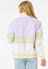 Giacca a blocchi di colore con pannelli in lavanda, verde e bianco. Texture morbida con orlo e polsini elastici per un look aderente.
