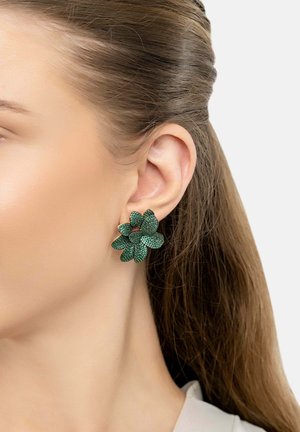 Green floral earrings with textured petals, featuring a glittery finish. Designed in a layered flower shape with a central accent.