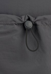 Gray fabric with a smooth texture, featuring a toggle and elastic cord for adjusting, and a stitched seam along the edge.
