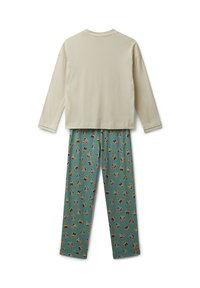 Top de manga larga en color crema combinado con pantalones de pijama en color teal que presentan un patrón repetido de animales de dibujos animados en tonos terrosos. Material de algodón suave.