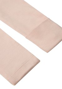 Hellrosa Stoffbeinhüllen mit gerippter Textur und geraden Enden. Verfügt über einen nahtlosen Abschluss an den Säumen und ein weiches Materialdesign.