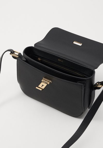 Black textured leather crossbody bag with a gold-tone clasp and strap. Features a zippered interior pocket and a flap closure.