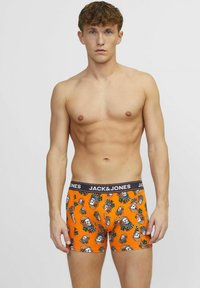 Boxer briefs para hombre en color naranja con una cinturilla negra con marca y vibrantes estampados de calaveras y flores. Fabricados con un tejido suave y elástico.