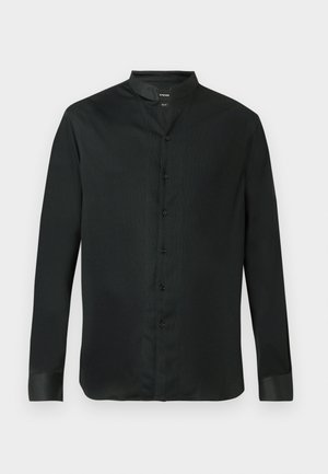 Juodas ilgomis rankovėmis marškinėliai su mandarinų apykakle, pagaminti iš lygaus audinio, su mygtukų užsegimu ir kontrastingomis rankovių dalimis.