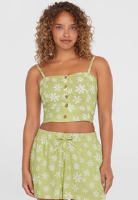 Hele roheline crop top valgete daisy-mustritega, reguleeritavad spagettiõlgedega ja n�ööpidega. Koostatud sobivate lillelise šortsidega.